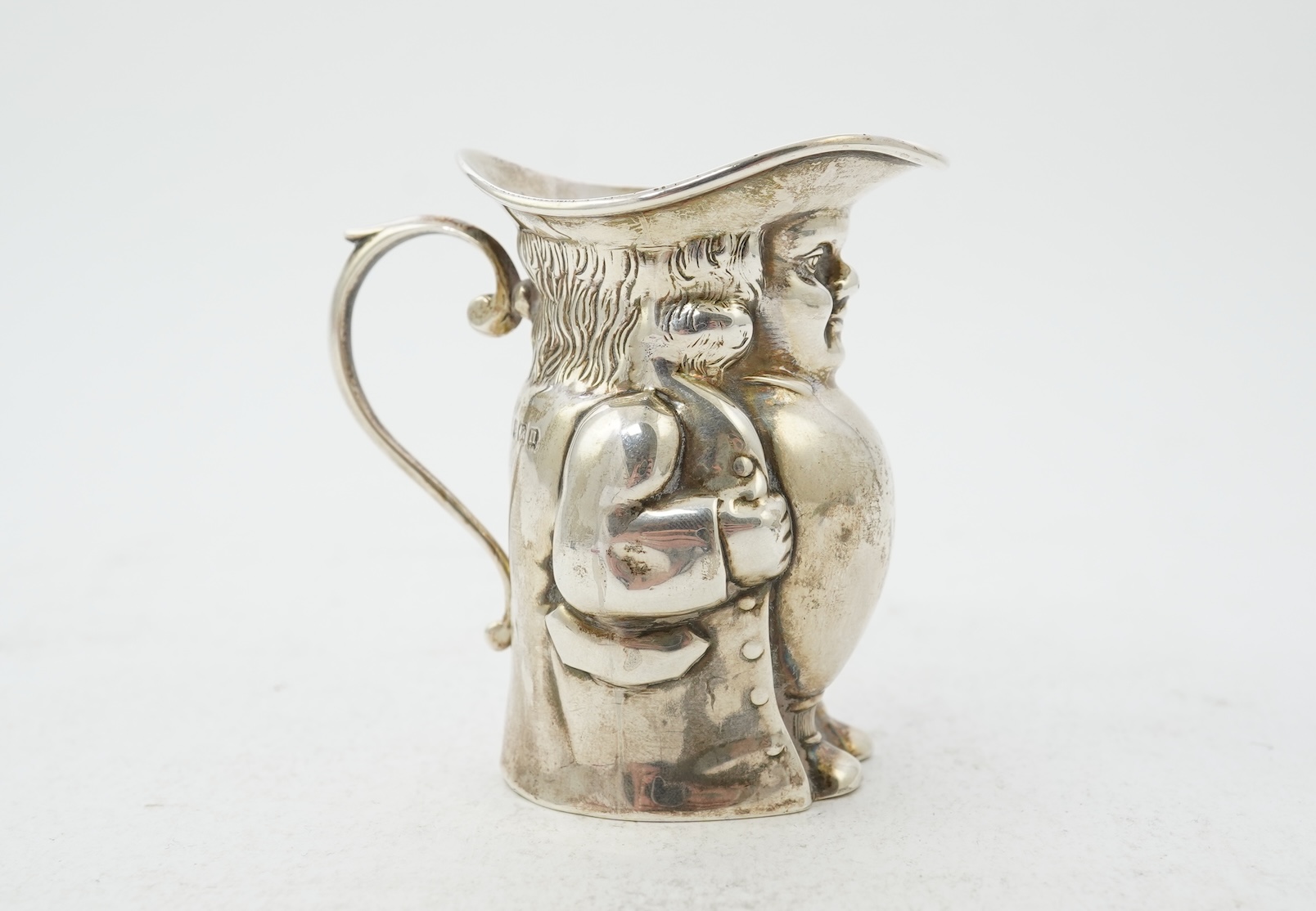A George V novelty silver cream jug, modelled as a Toby Jug, by Hayes & Co